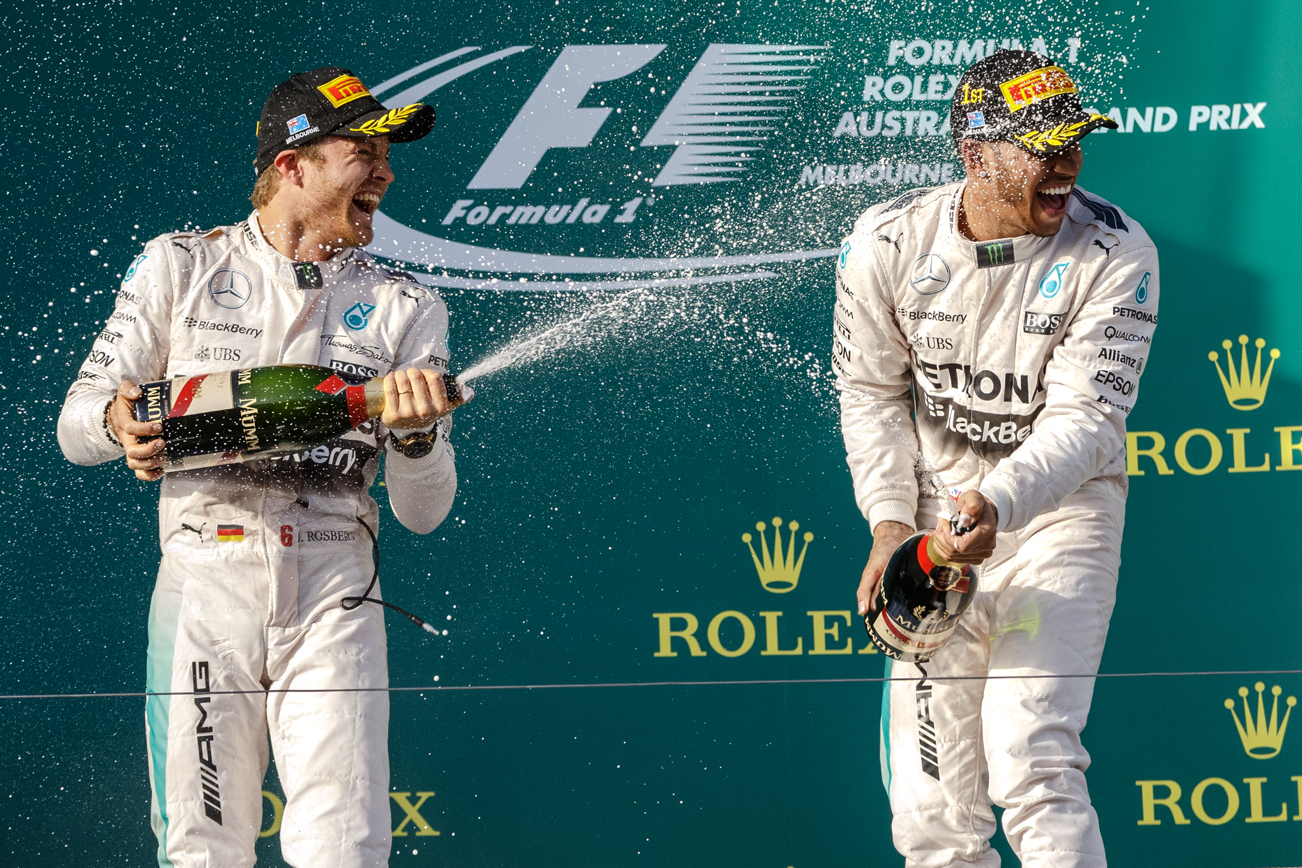 MELBOURNE - March 15, 2015: Lewis Hamilton (GBR) #44 (1st) and Nico Rosberg (DEU) #6 (2nd) spray champagne on the podium at the 2015 Australian Formula One Grand Prix at Albert Park, Melbourne, Australia. 20150315_SSYC4594
